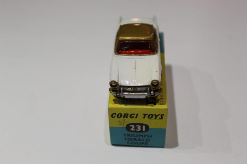 Vintage Corgi Toys 231 Triumph Herald Coupe model car on display.