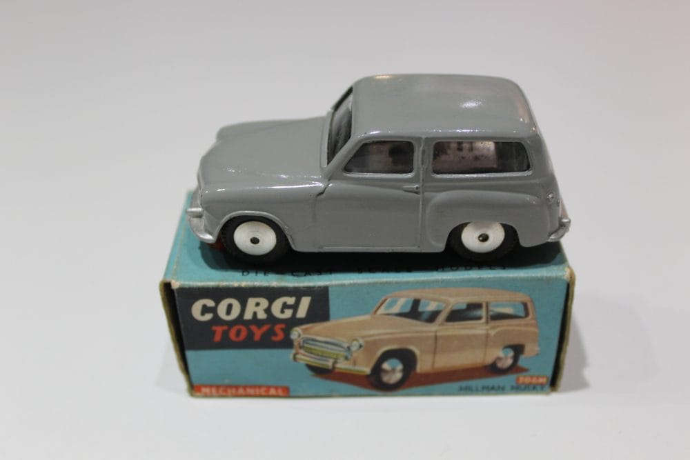 Vintage Corgi Hillman Husky Estate diecast model car, grey with white wheels, on original box.