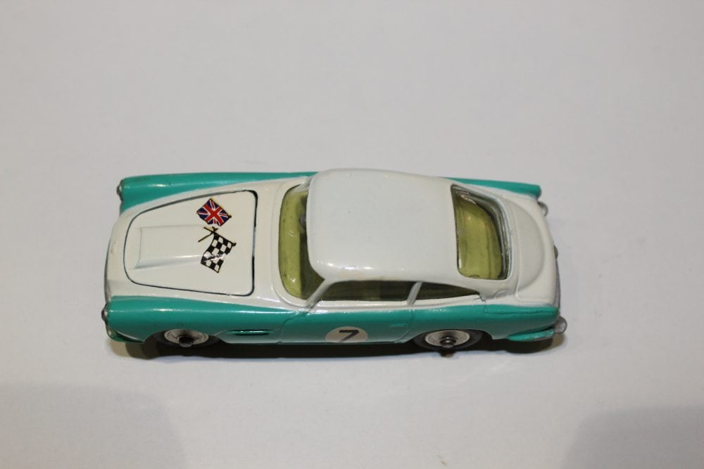 Detailed Corgi Toys 309 Aston Martin DB4 model with racing decals and green interior.