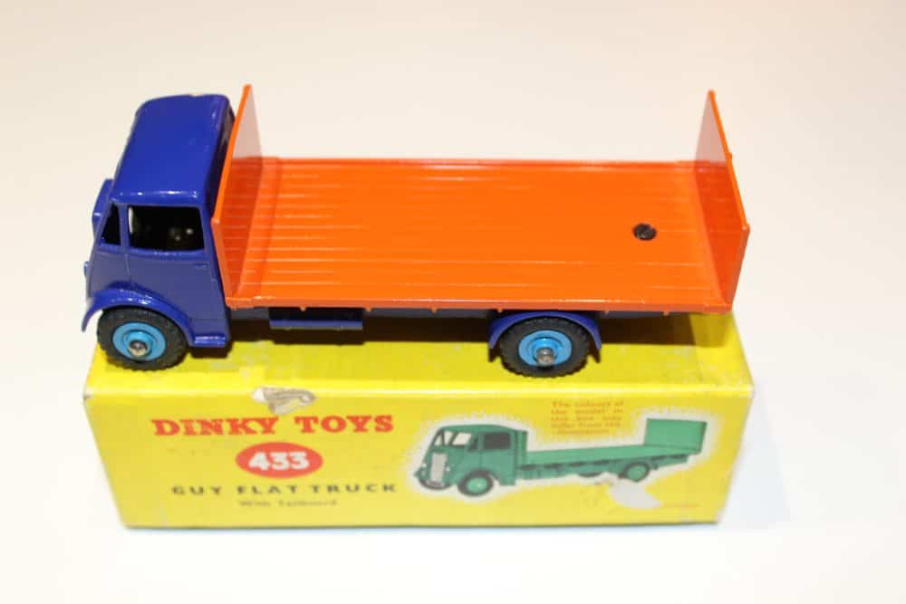 Vintage Dinky Toys 433 Guy flatbed truck with orange bed and blue cab.