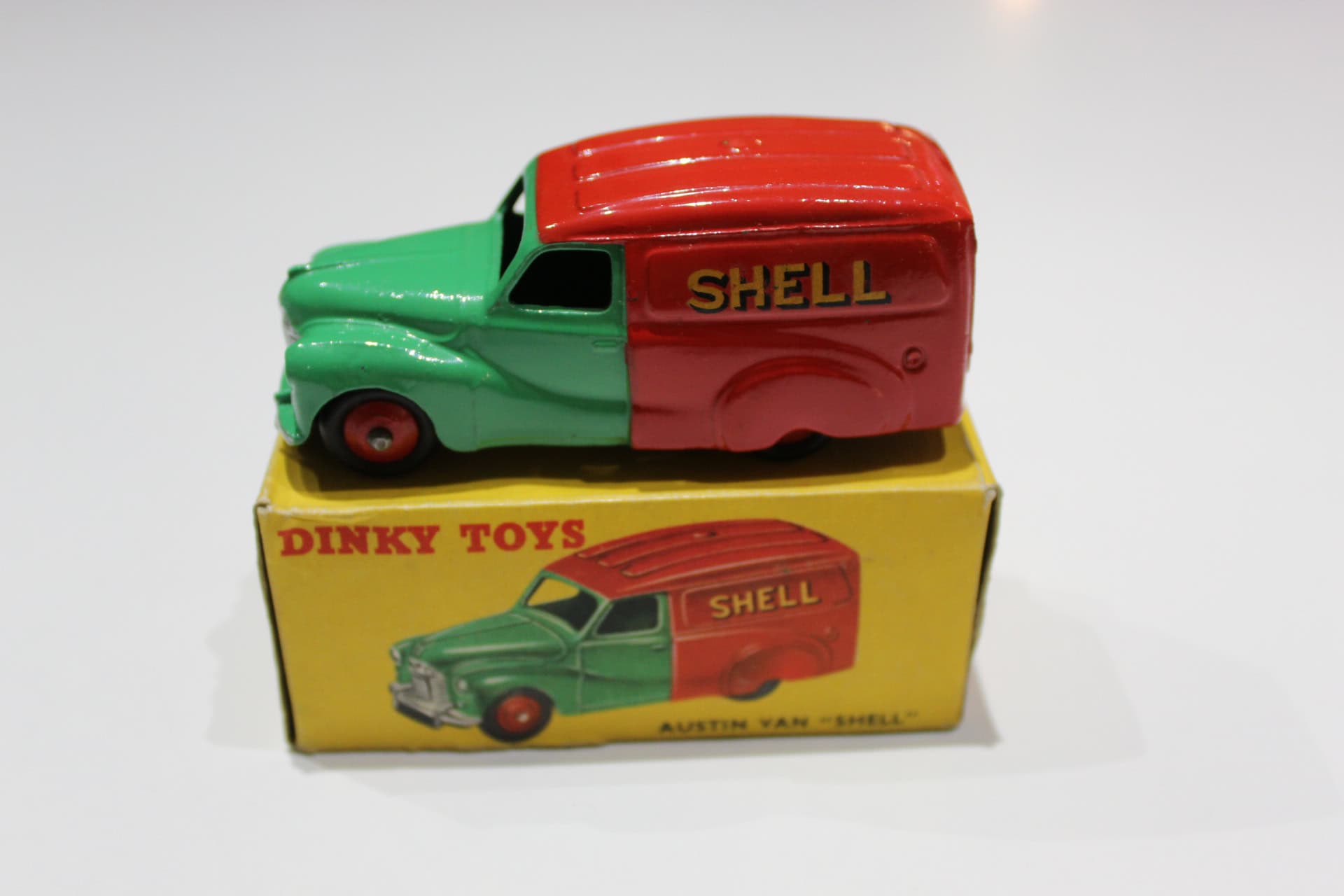 Vintage Dinky Toys Austin Shell Van model in green and red, with original box.