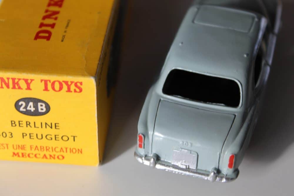 Detailed model of a grey Dinky Toys 24B Peugeot 403 Berline with original box.