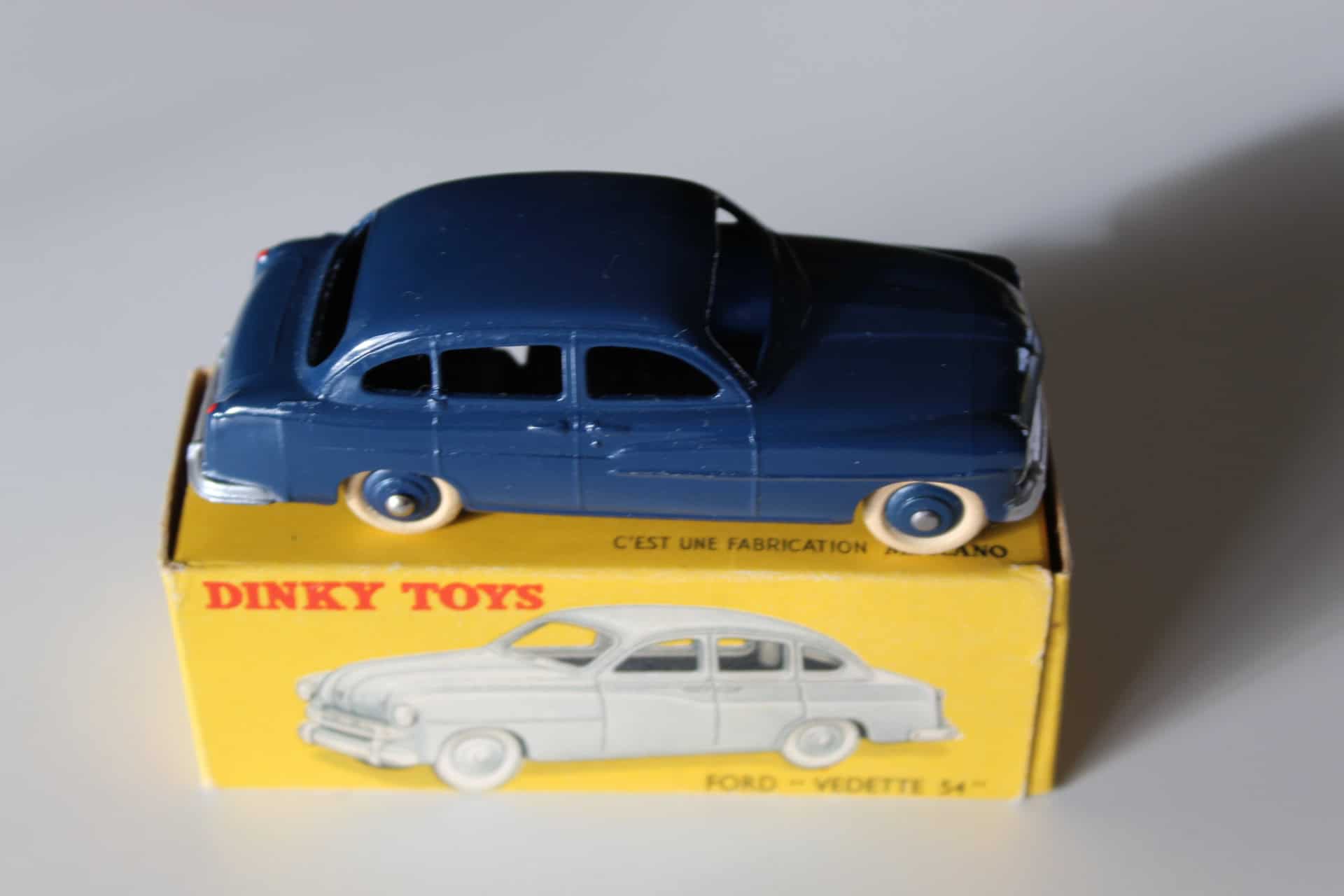 Vintage Dinky Toys Ford Vedette '54 model car on box, collectible diecast toy.