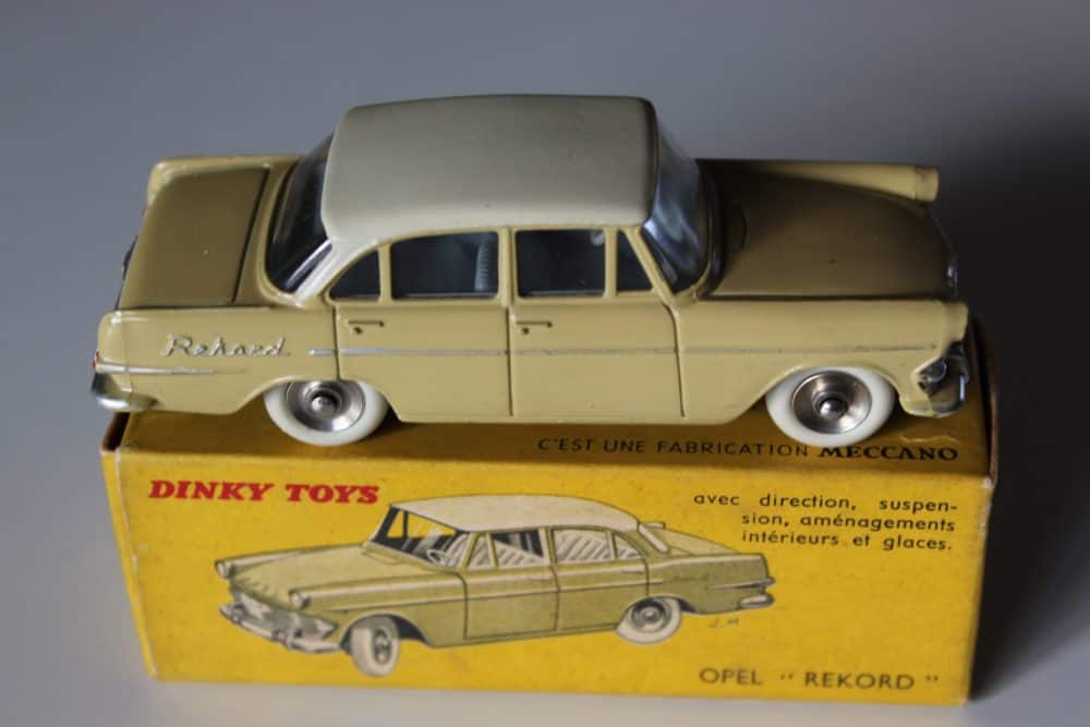 Vintage Dinky Toys Opel Rekord model car, yellow with grey roof, on original box.
