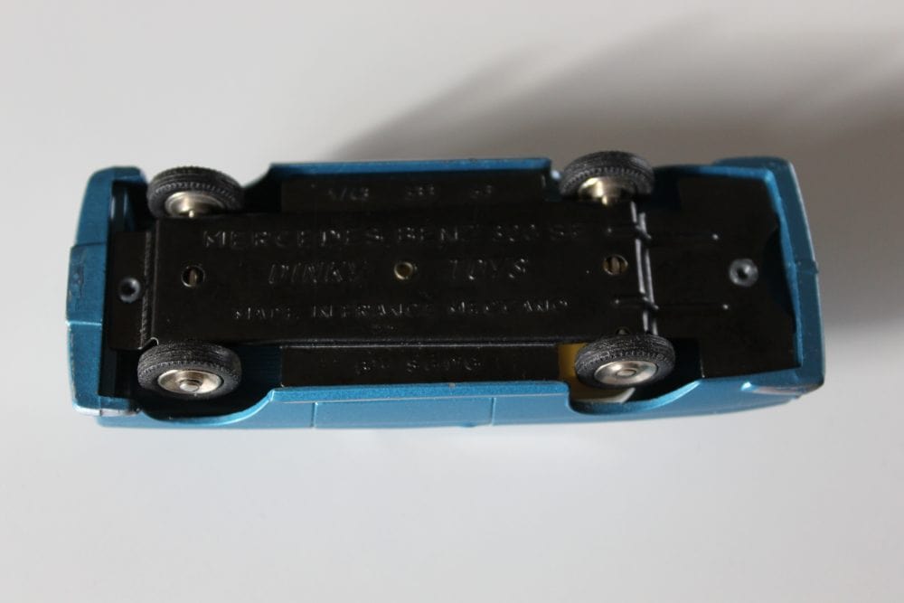 Dinky Toy 533 Mercedes Benz 300 SE Coupe model in blue, underside view showing details.