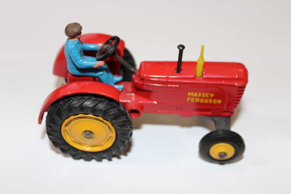 Vintage Dinky Toys Massey Ferguson tractor model with driver figure.