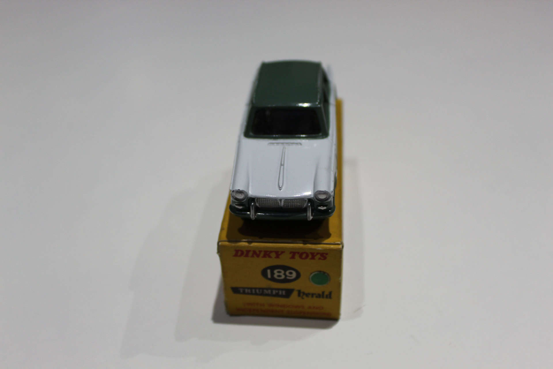 Dinky Toys 189 Triumph Herald diecast model on promotional box, rare collectible toy.