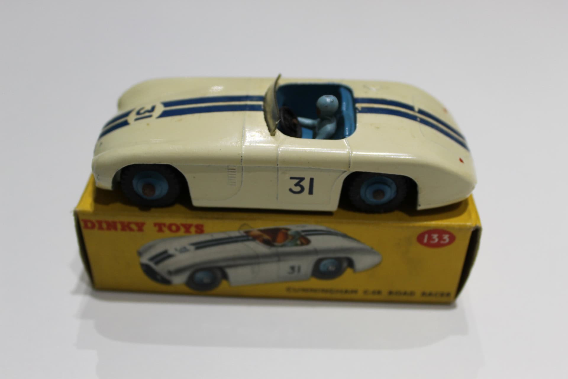 Dinky Toys 133 Cunningham C5-R racing car model on yellow box, collectible diecast toy.