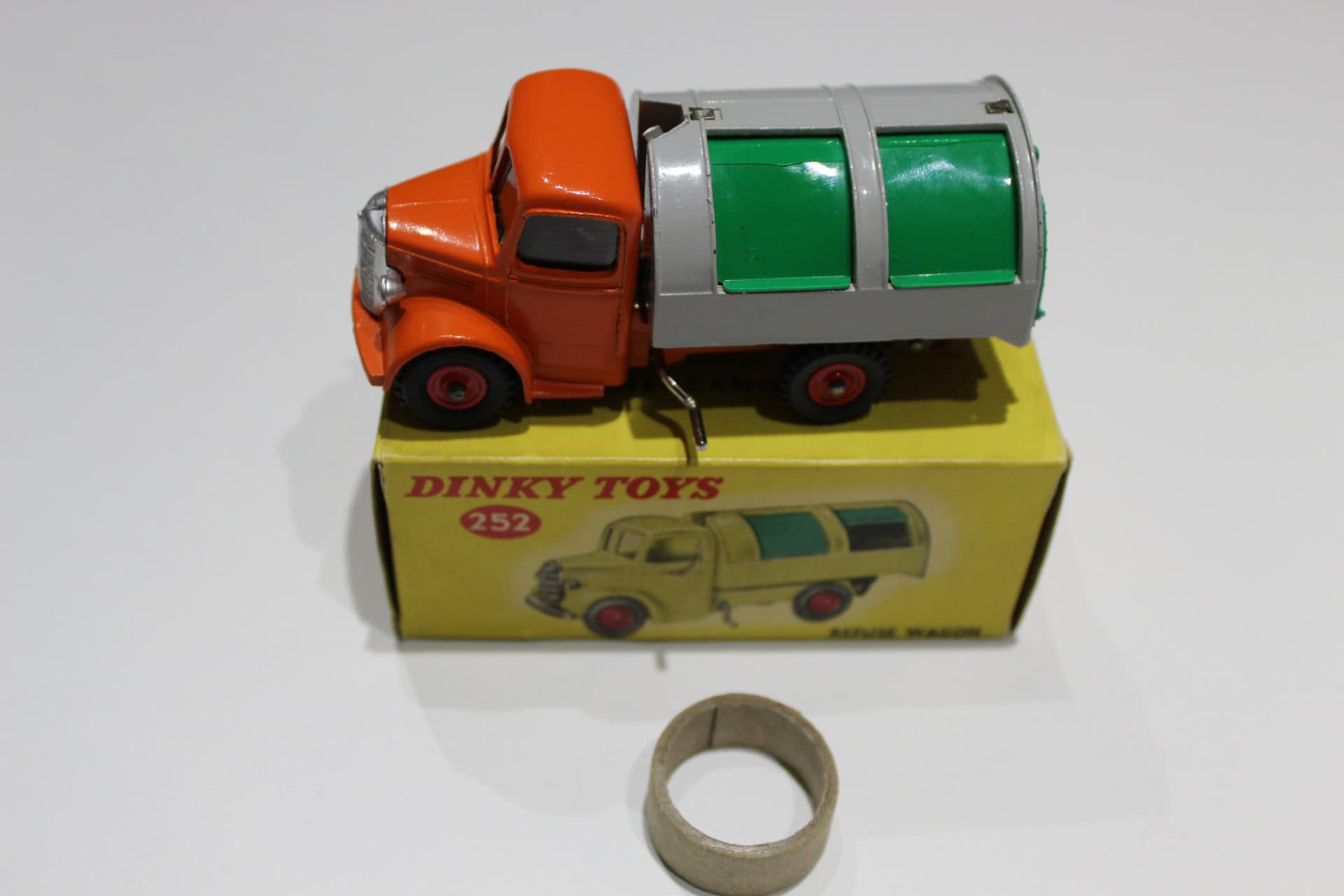 Vintage Dinky Toys refuse wagon with green and orange details, collectible model for diecast toy ent.