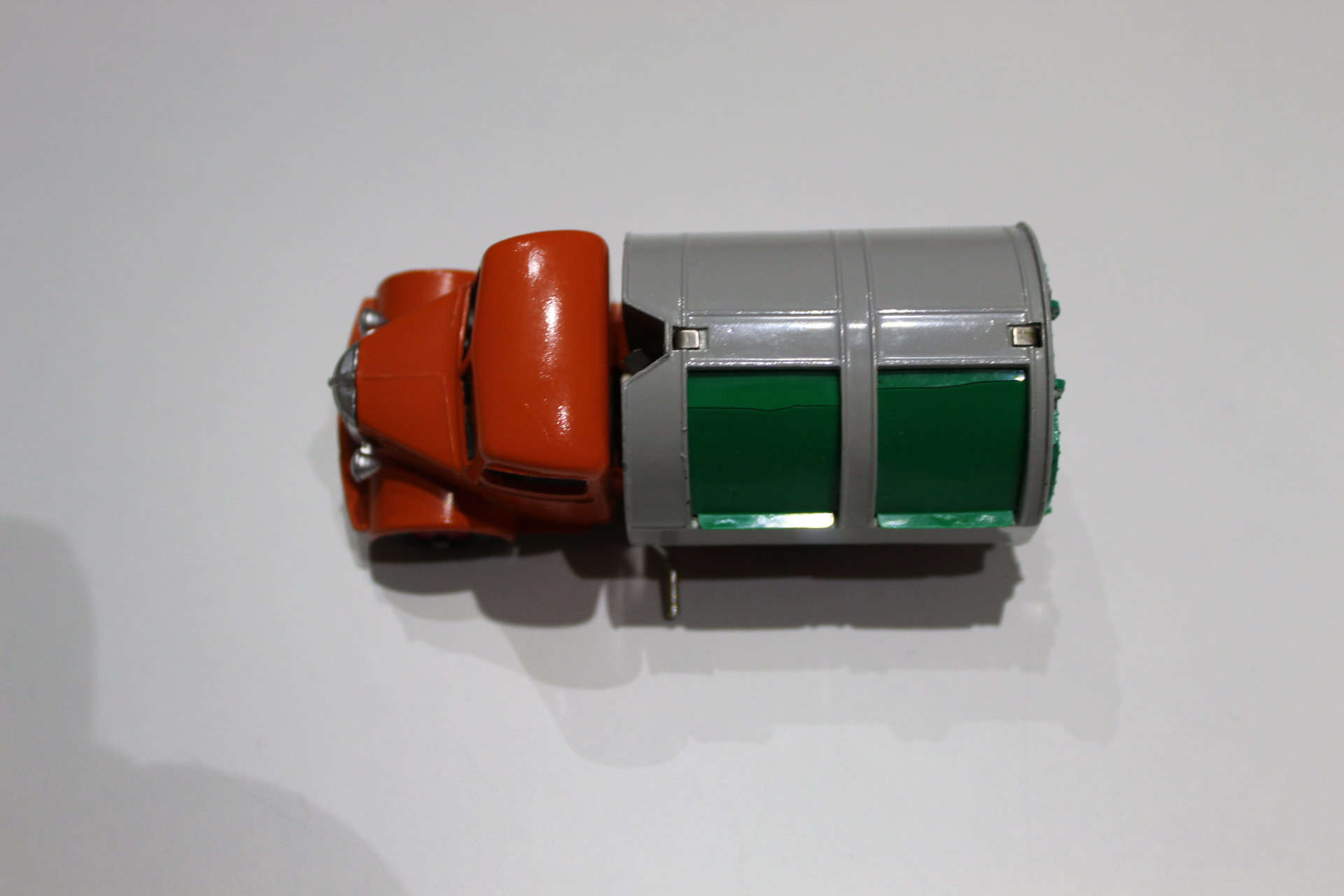 Vintage Dinky Toys refuse collection truck with orange cab and green waste bins.