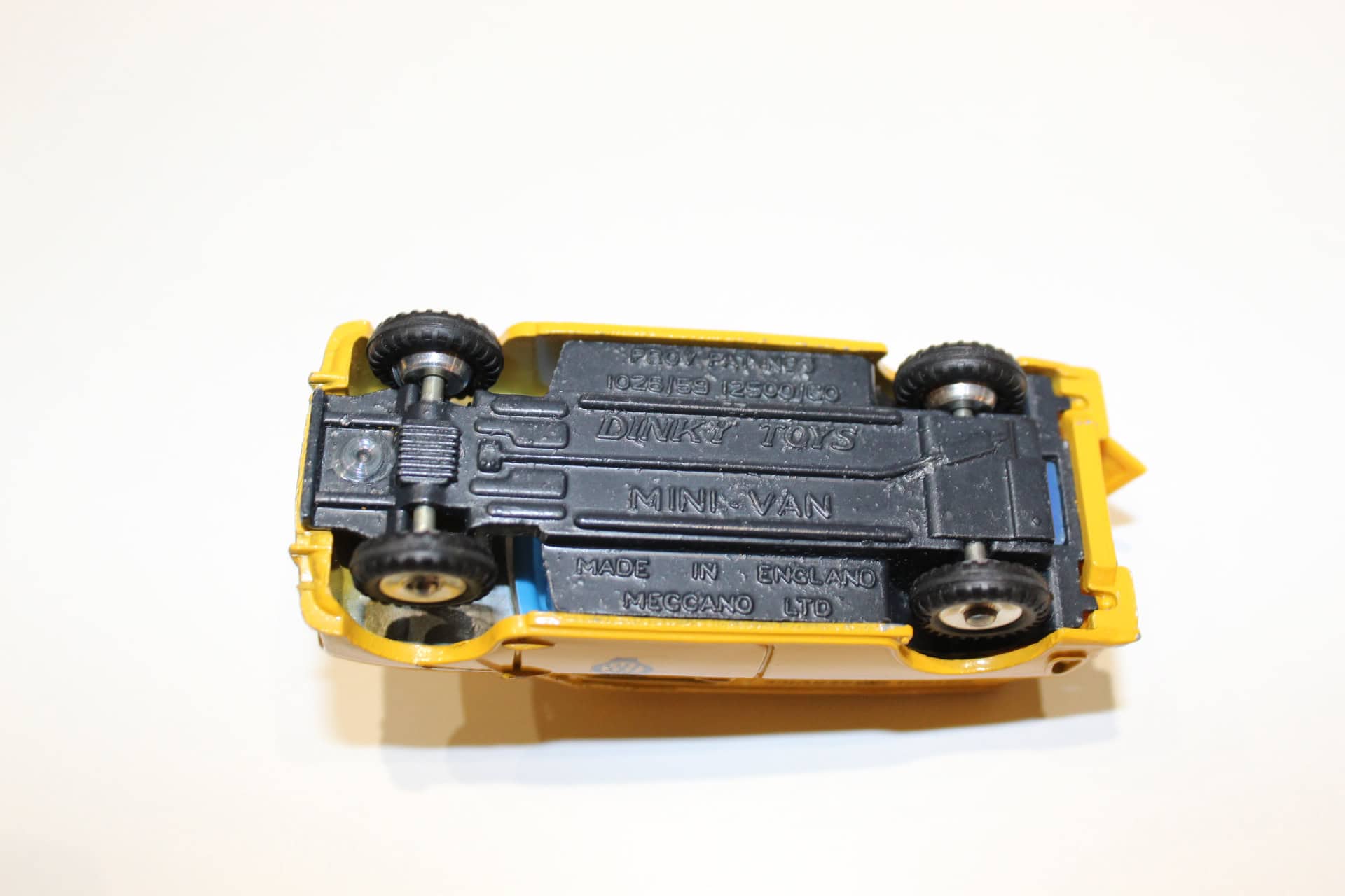 Dinky Toys 274 A.A. Mini Van diecast model in yellow and black, vintage toy vehicle.