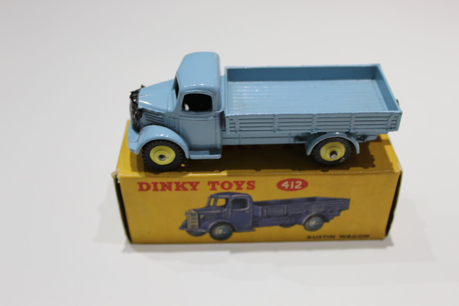 Vintage Dinky Toys 412 Austin Wagon model on original box, diecast toy vehicle.