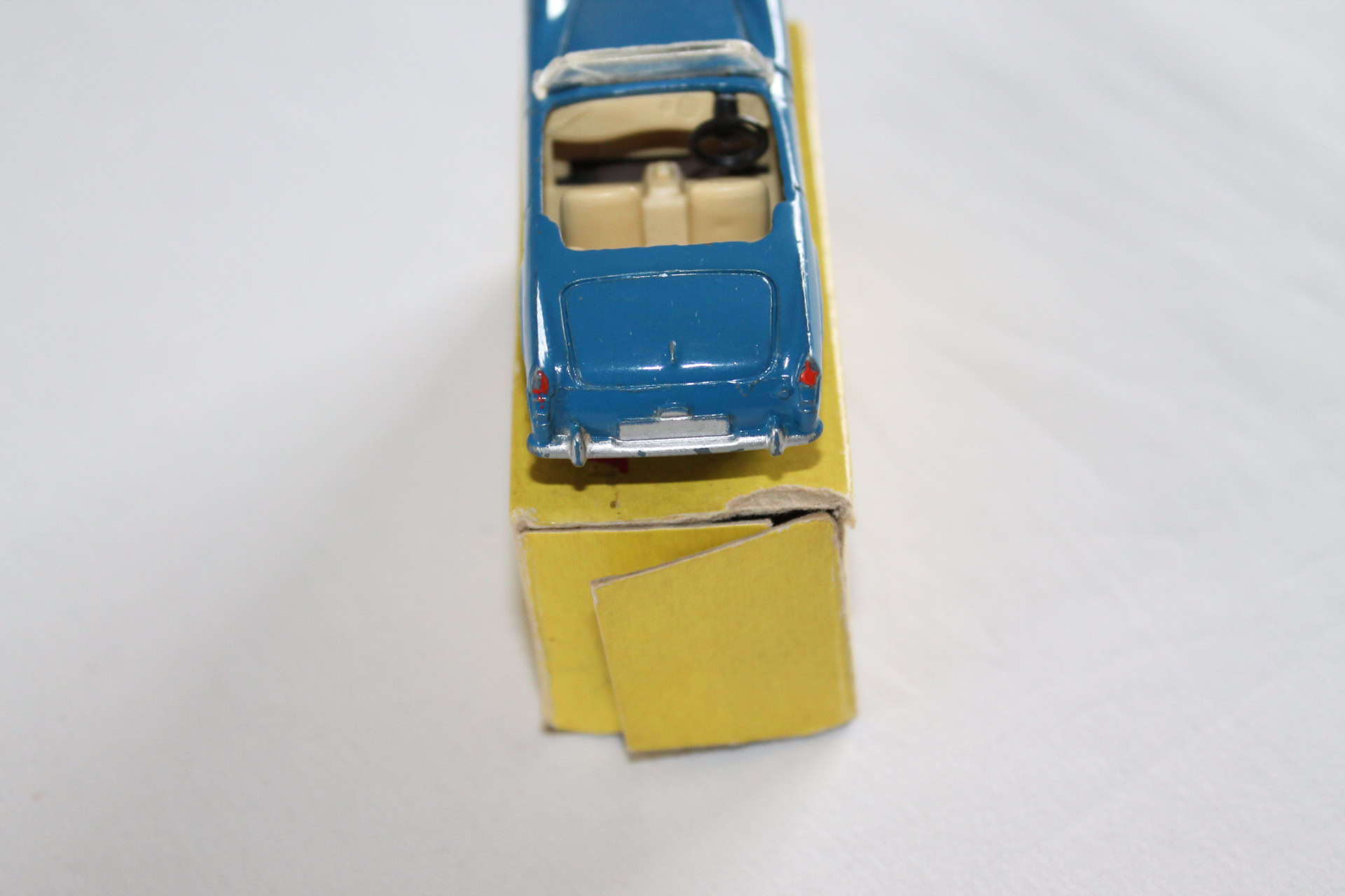 Vintage Dinky Toys 112 Austin Healey model on yellow packaging.