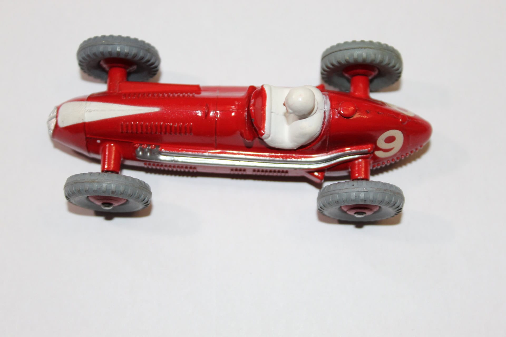 Dinky Toys 231 Maserati racing car in red with grey wheels, detailed vintage diecast model.