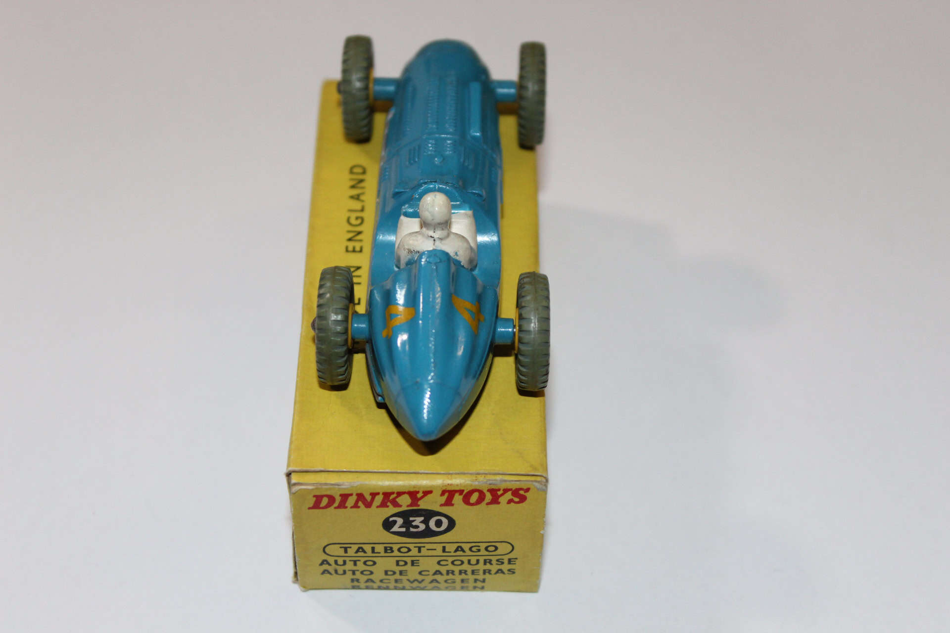 Vintage Dinky Toys 231 Maserati racing car on yellow display stand.