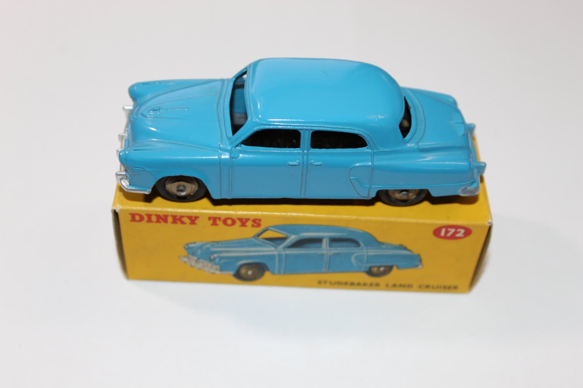 Vintage blue Dinky Toys 172 Studebaker Land Cruiser model car on original box.