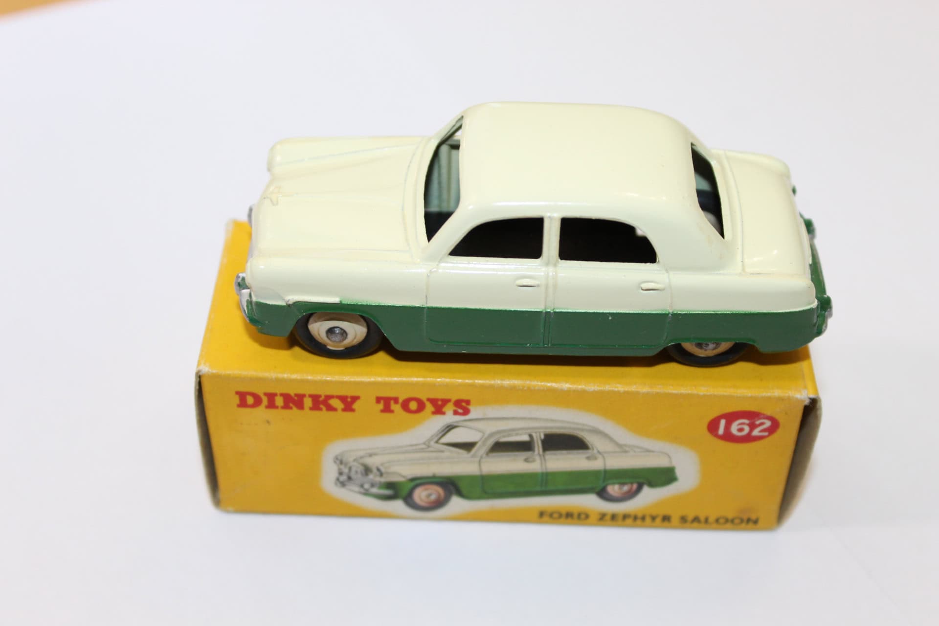 Vintage Dinky Toys 162 Ford Zephyr model in green and cream, displayed on original box.