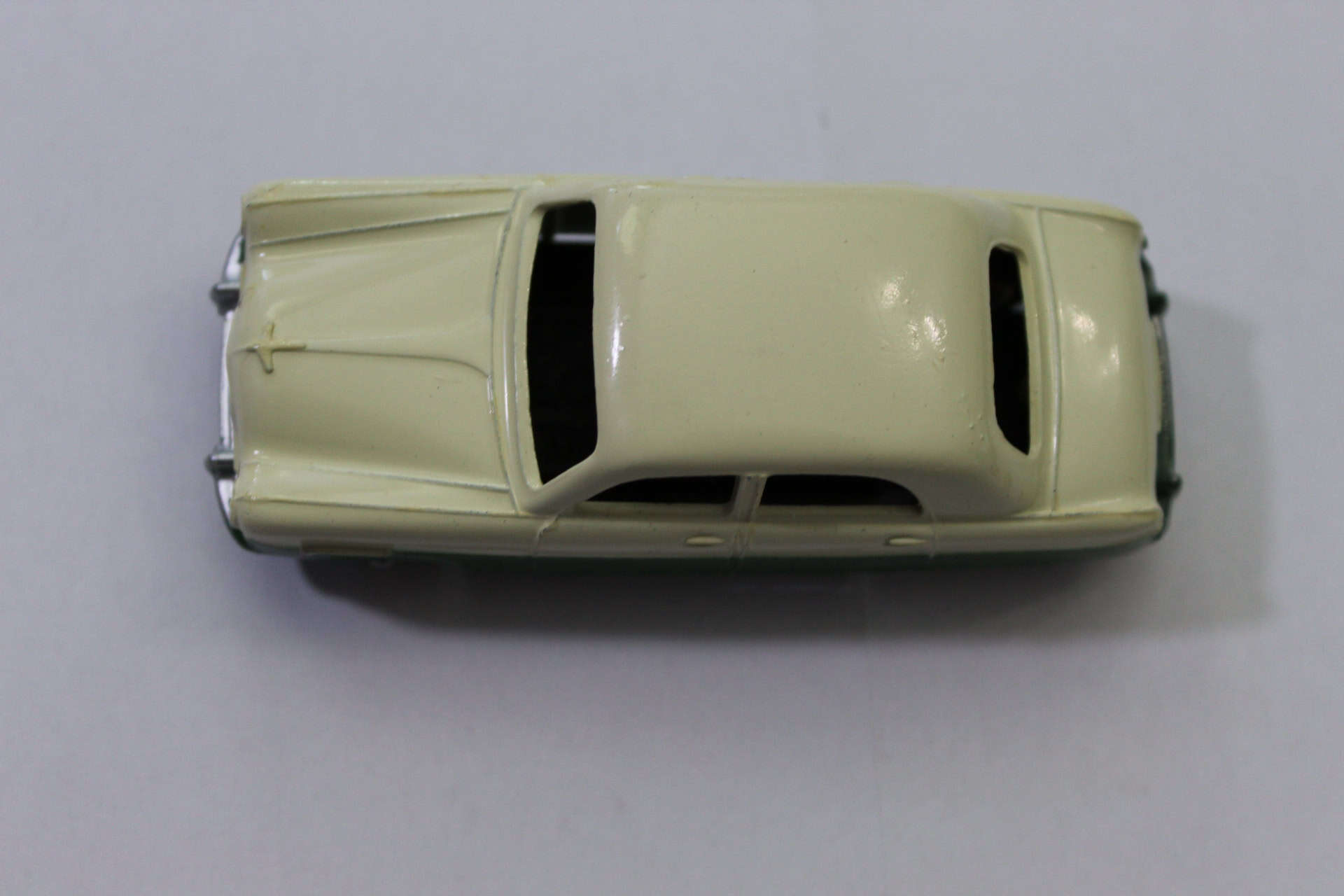Vintage Dinky Toys Ford Zephyr model in green and cream color, top view.