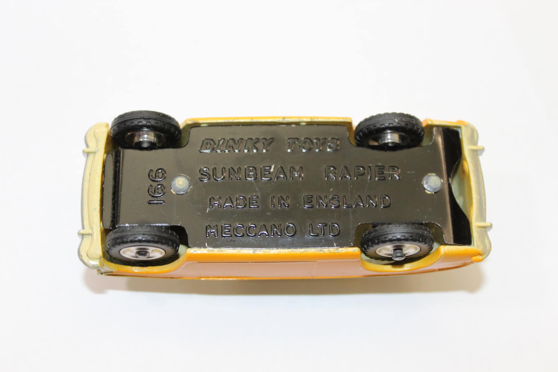 Close-up of Dinky Toys 166 Sunbeam Rapier diecast model underside showing details.