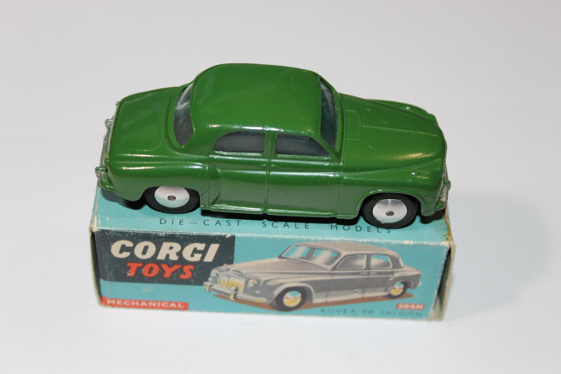 Detailed green diecast model of Corgi Toys Rover 90 Saloon on original box.