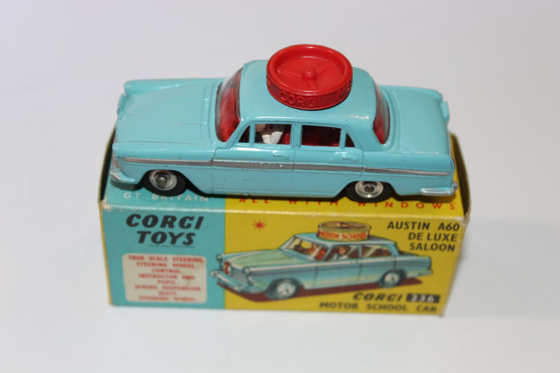 Vintage Corgi Toys 236 Motor School Car with red siren on light blue body.
