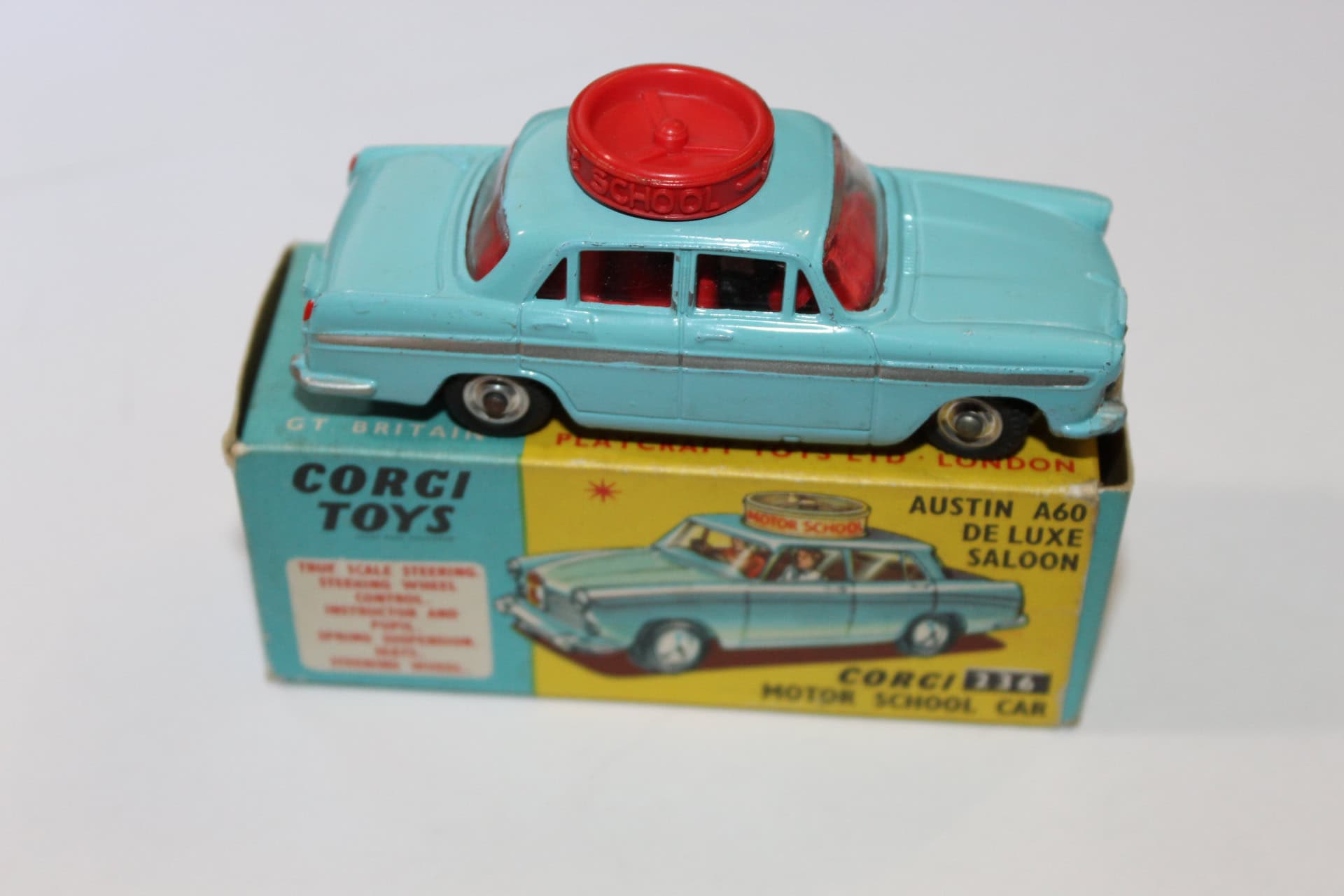 Vintage Corgi Toys 236 Motor School Car with red siren, blue body, and original box.