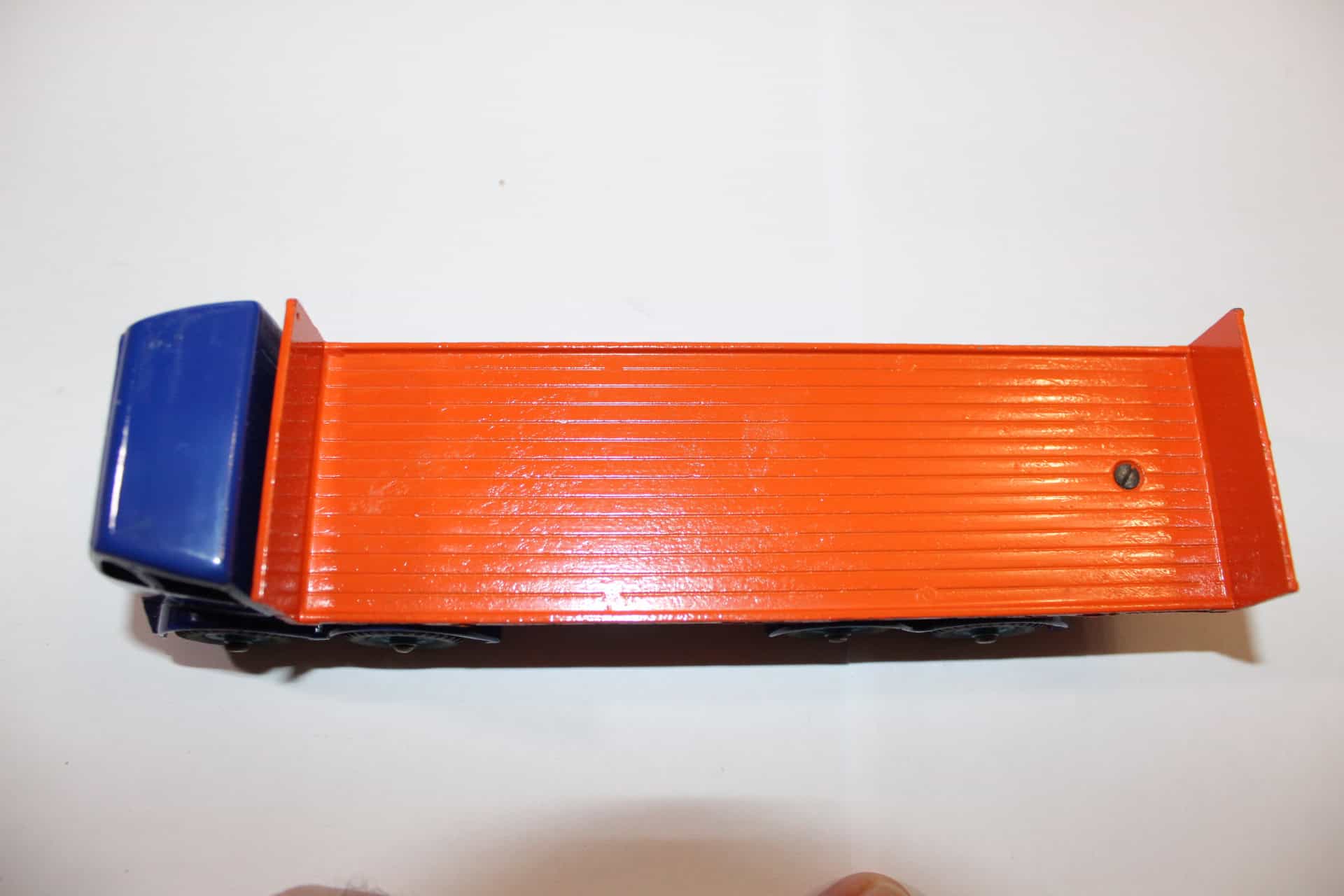 Detailed Dinky Toys 903 flat truck with tailboard, orange bed and blue cab.