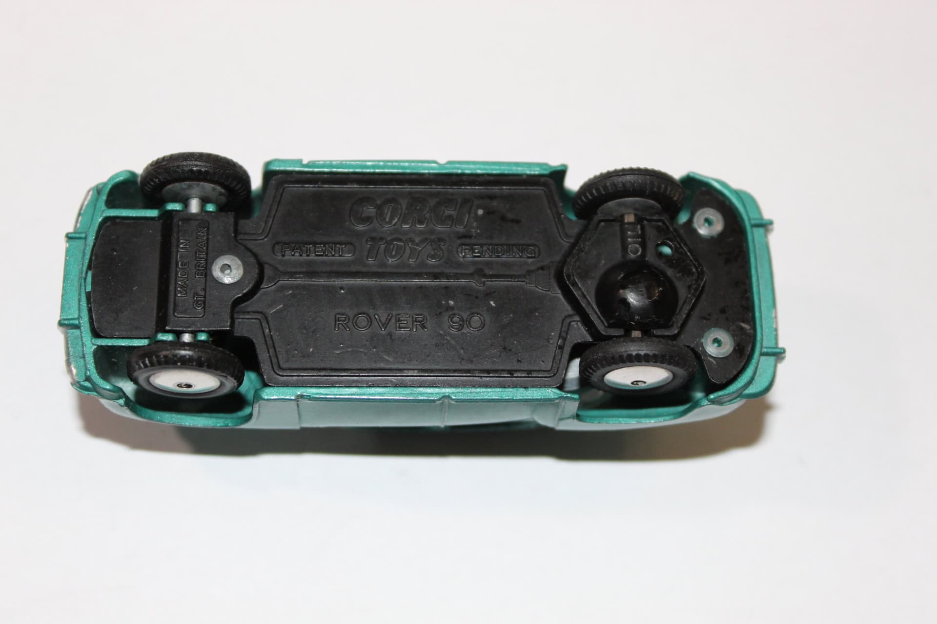 Detailed Corgi Rover 90 Saloon diecast toy car, underside view.