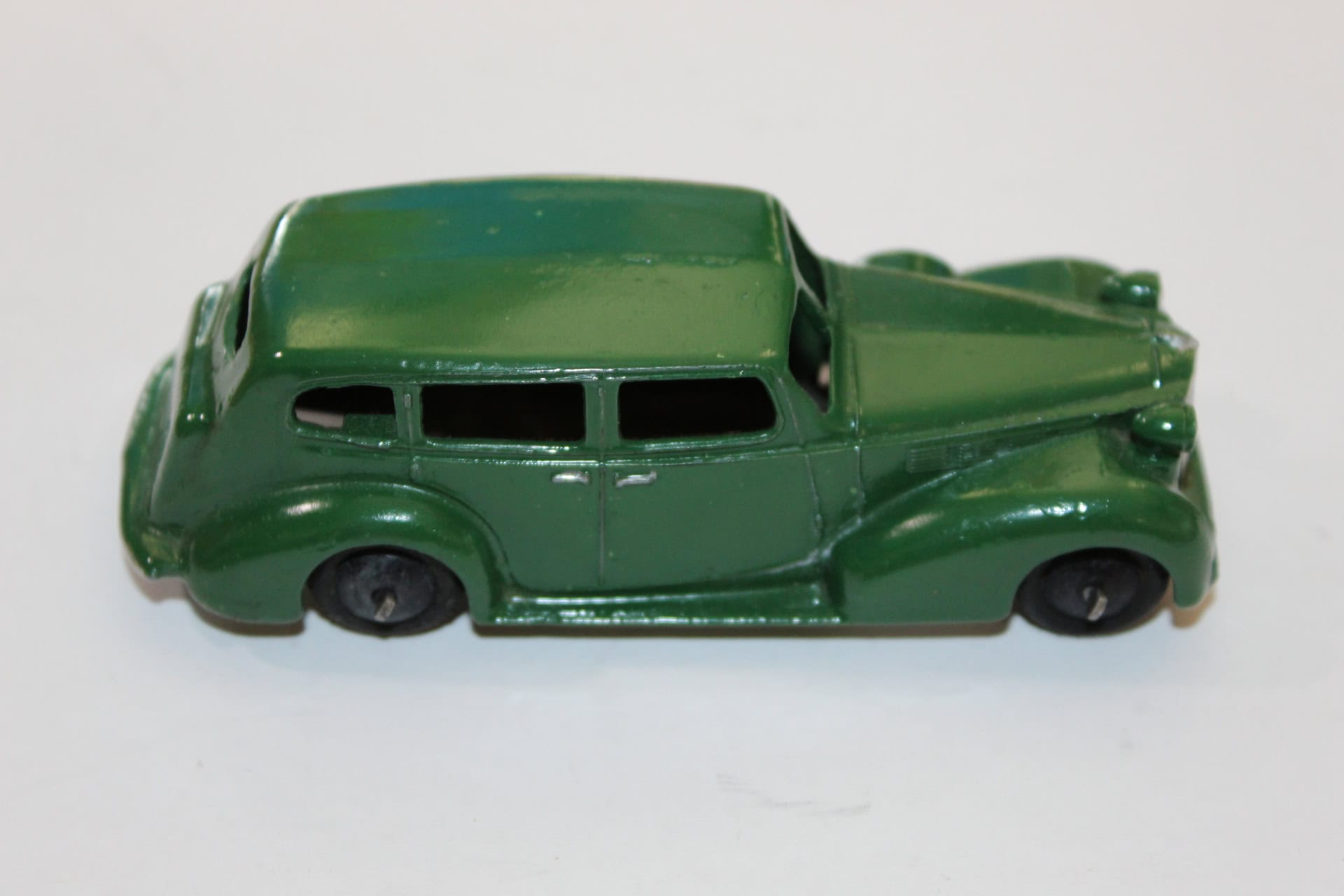 Vintage green diecast Corgi Chevrolet police car model.