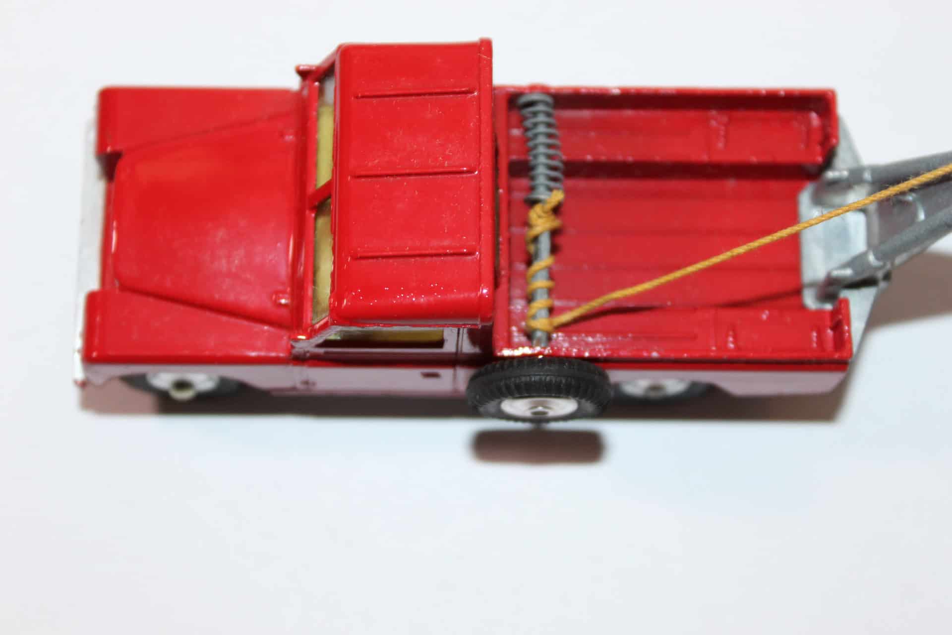 Vintage Corgi Land-Rover breakdown truck toy with towing equipment and red finish.