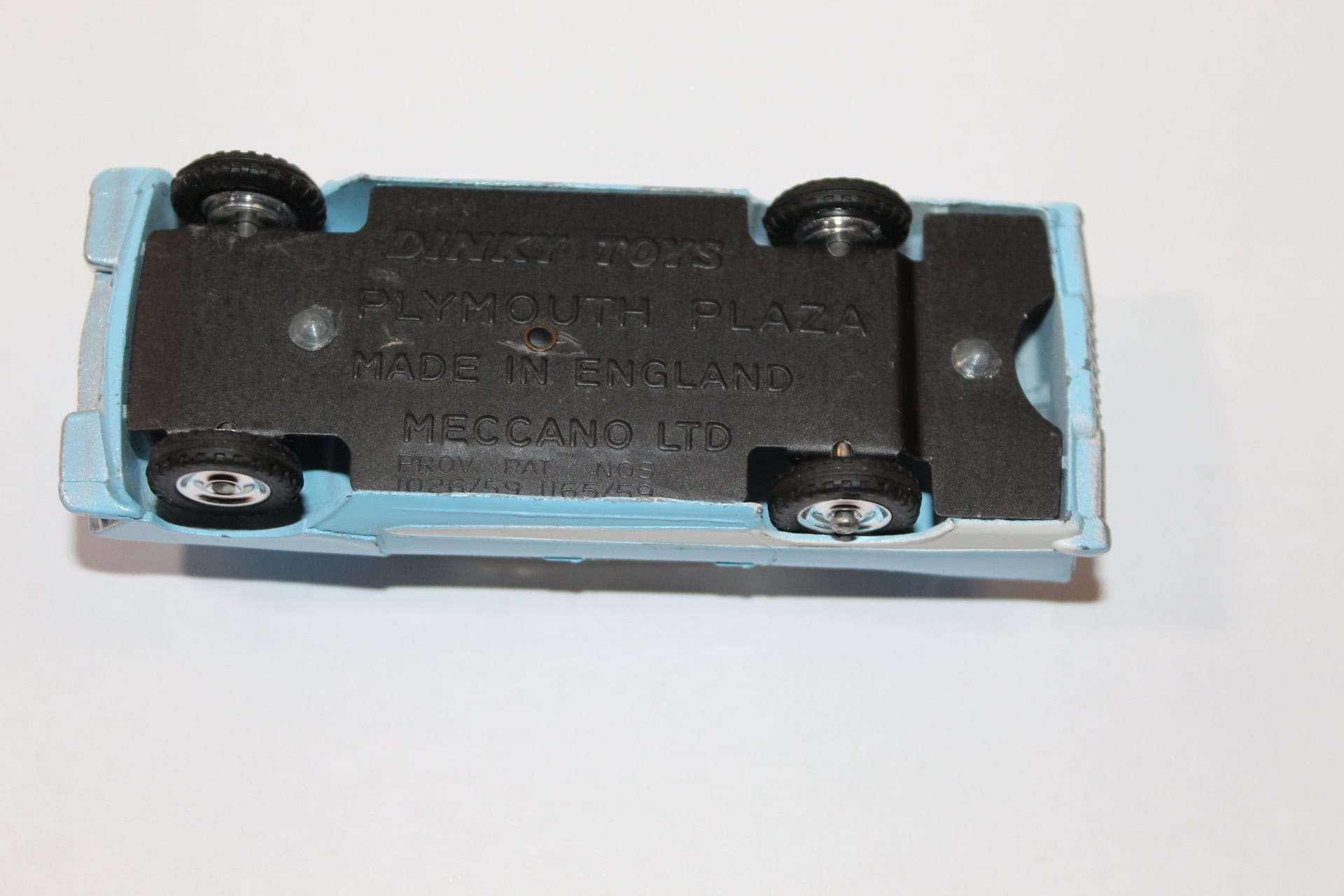 Close-up of the underside of a Dinky Toys 178 Plymouth Plaza diecast model car showing manufacturing.