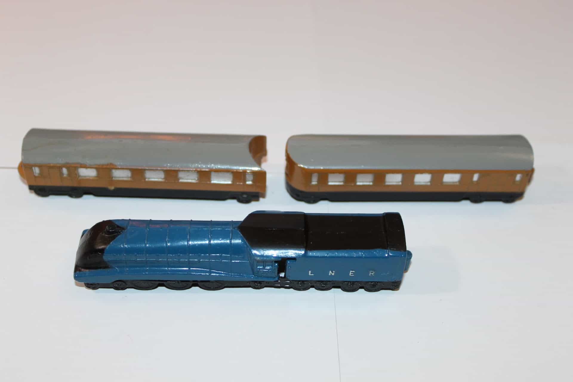Vintage Dinky Toys 016 train passenger cars and locomotive model.