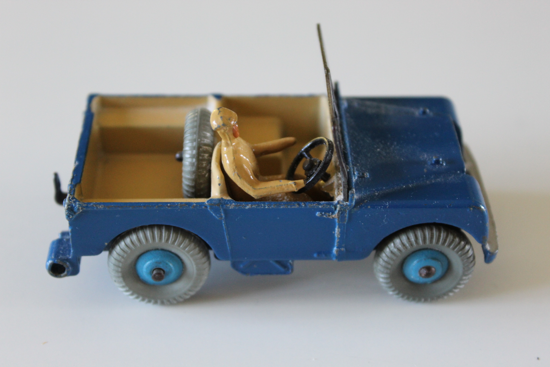 Vintage blue Dinky Toys Land-Rover with beige interior and steering wheel.