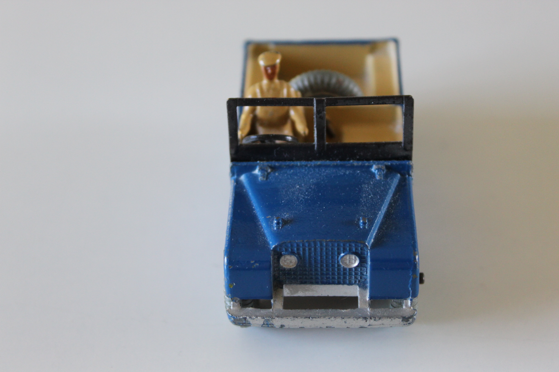Vintage Dinky Toys 27d Land-Rover with driver figure and open top.