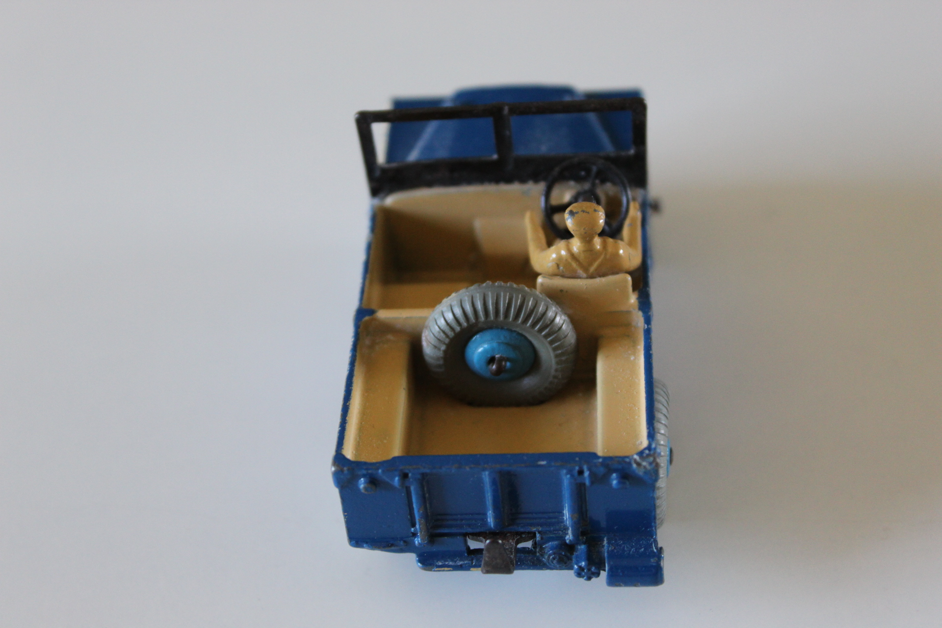 Vintage Dinky Toys 27d Land-Rover model with driver and spare wheel.