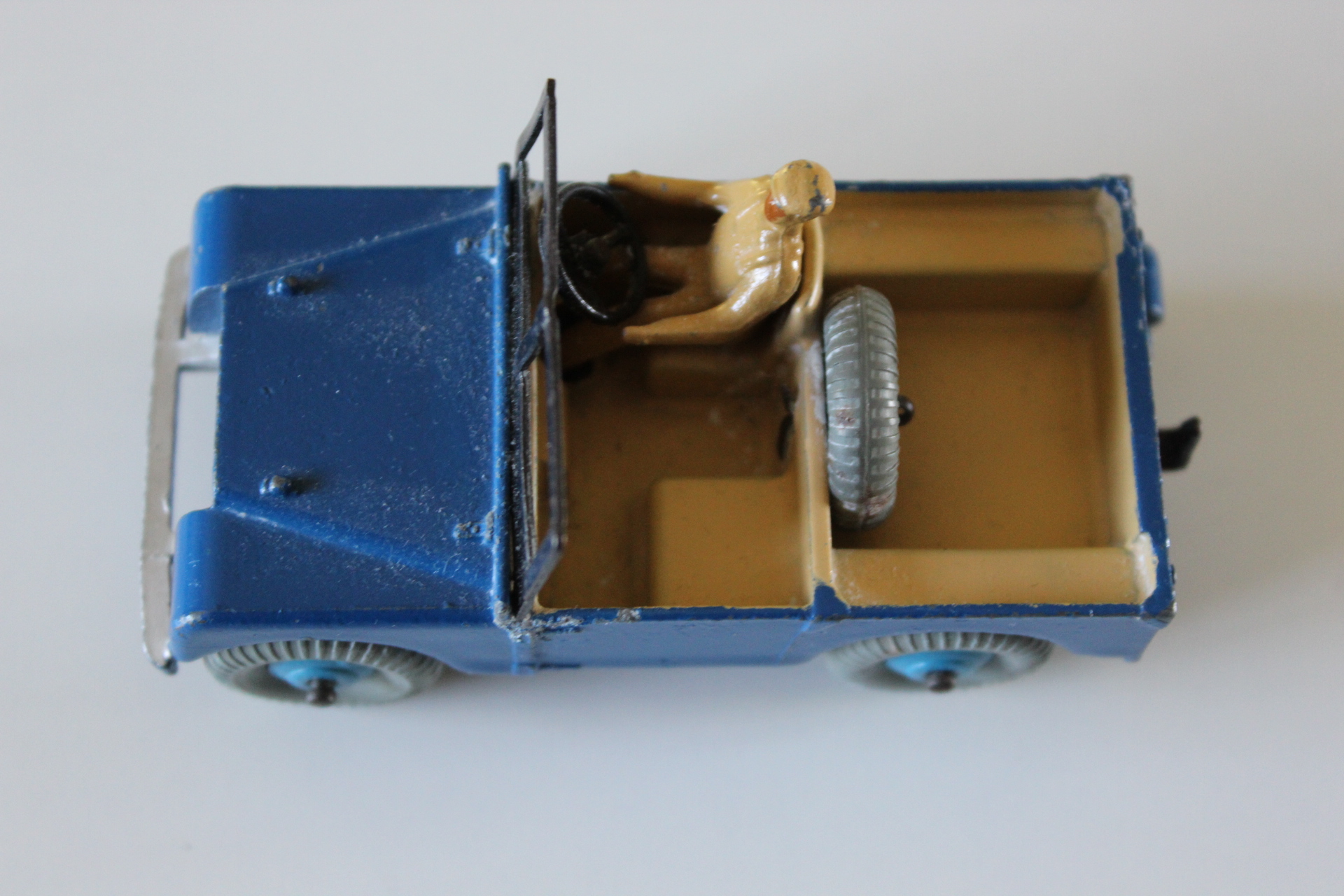 Vintage blue Dinky Toys Land-Rover with beige interior and black steering wheel.