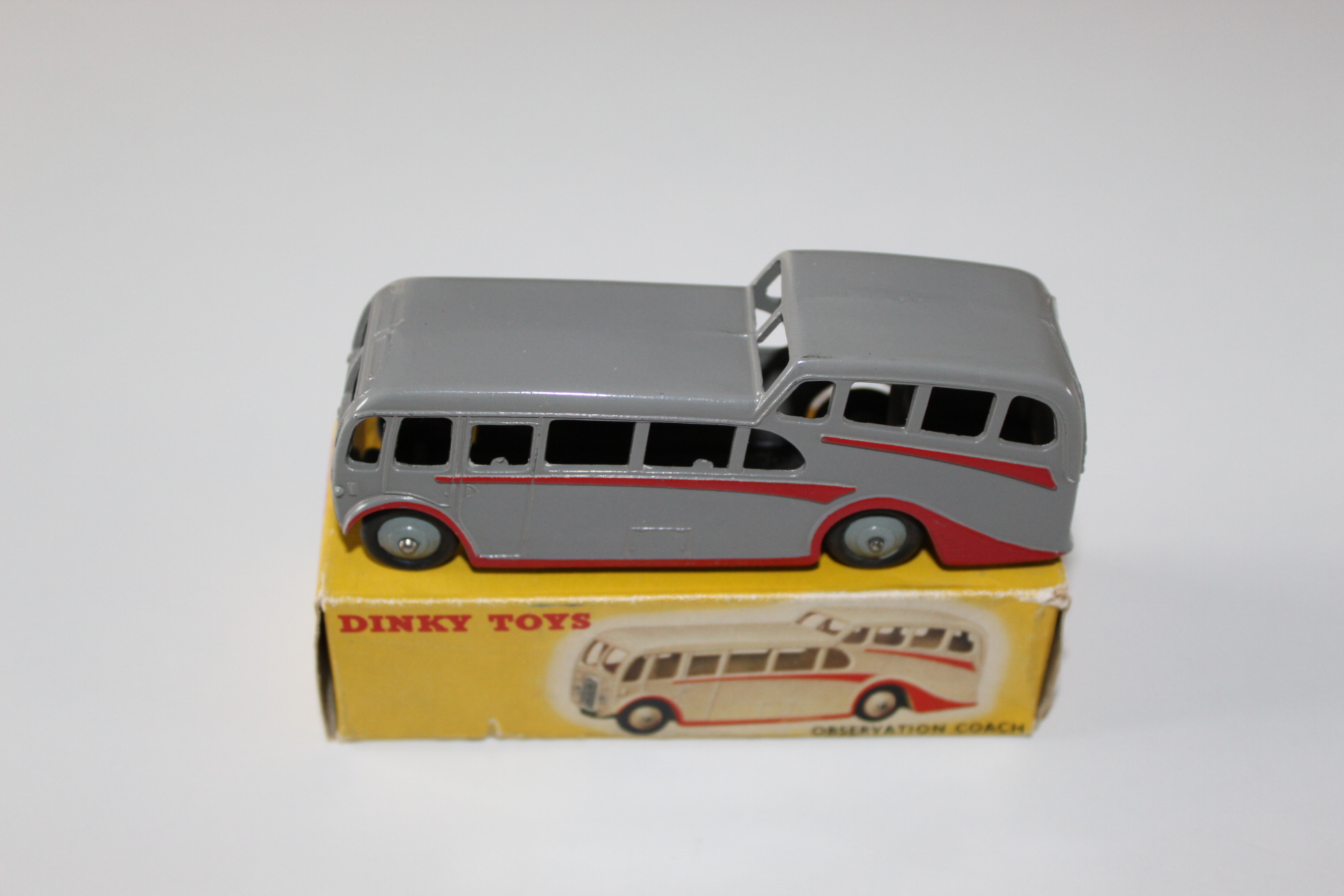 Vintage Dinky Toys observation coach model on its original box for collectors.